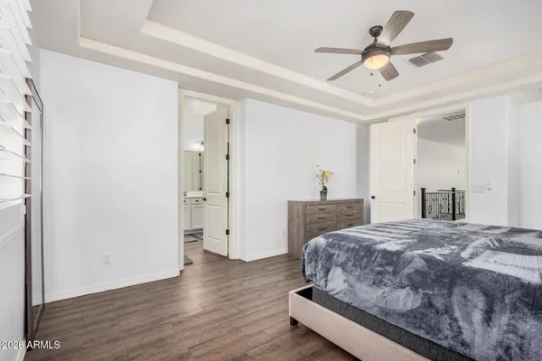 a spacious bedroom with a bed and a chandelier