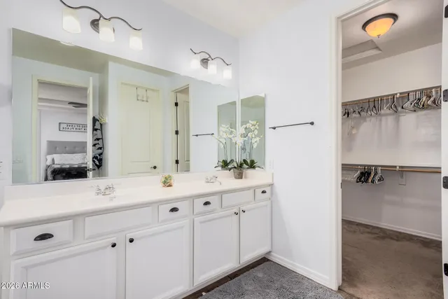 a bathroom with a double vanity sink a mirror a bathtub and shower