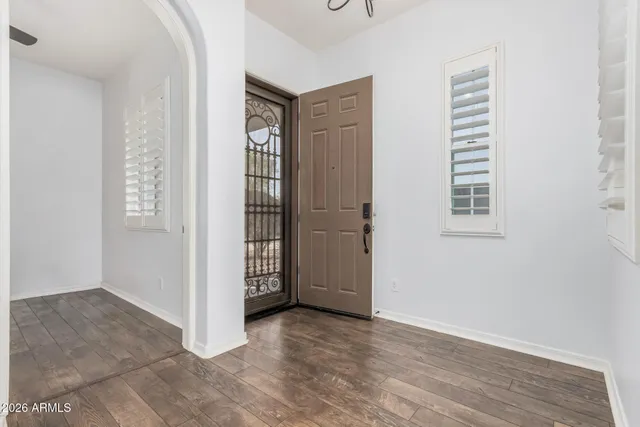 an empty room with windows and closet