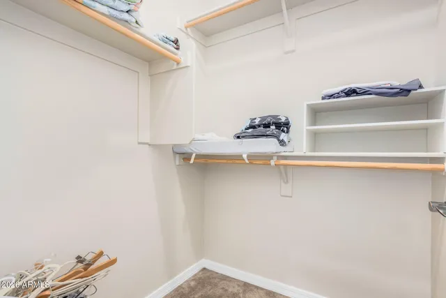 an empty room with wooden floor and a window