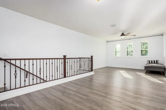 a bedroom with a bed and a ceiling fan