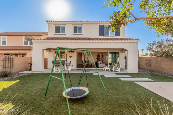 a front view of a house with a garden and patio