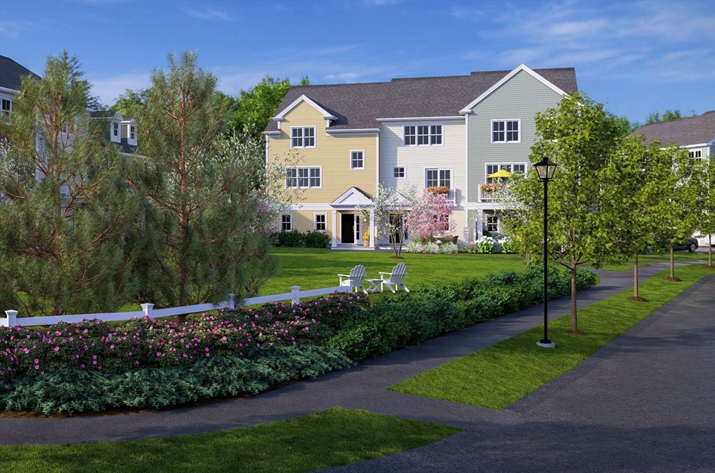 0 Oxbow Road, Unit 39 Raynham, MA 02767 - Photo 4 of 24 a front view of a house with a yard