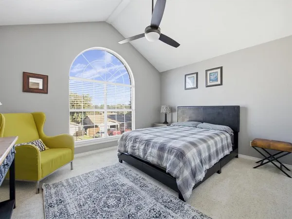 a bedroom with a bed couch and a window