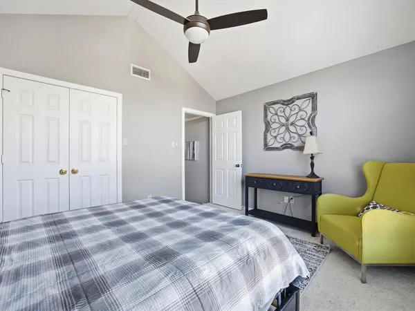 a bedroom with a bed and a couch