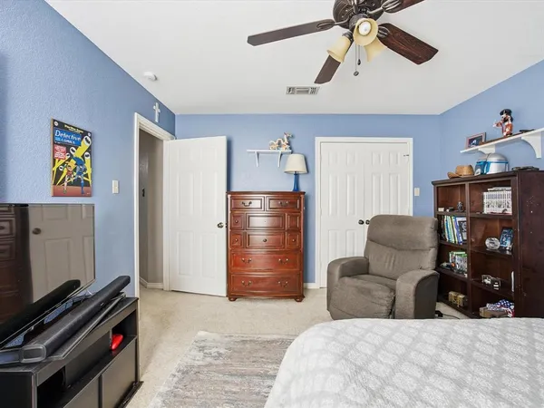a bedroom with furniture and wooden floor