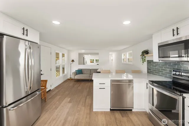 a kitchen with stainless steel appliances a refrigerator and cabinets