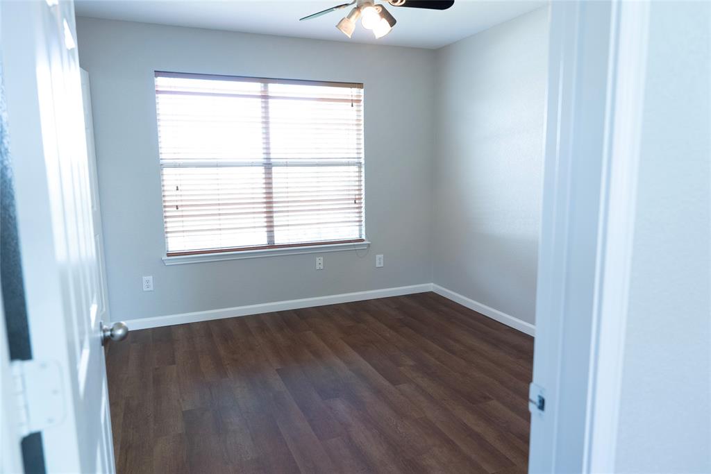 8805 Graywolf Ridge Trail Fort Worth, TX 76244 - Photo 17 of 23 Room featuring wood-finish flooring, a window with blinds, a ceiling fan, and light gray walls