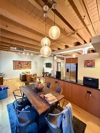 a living room with lots of furniture and a large window