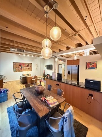 111 Beach Street, Unit 2B Boston, MA 02111 - Photo 3 of 8 a living room with lots of furniture and a large window