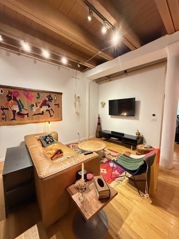 111 Beach Street, Unit 2B Boston, MA 02111 - Photo 4 of 8 a room with furniture and flat screen tv