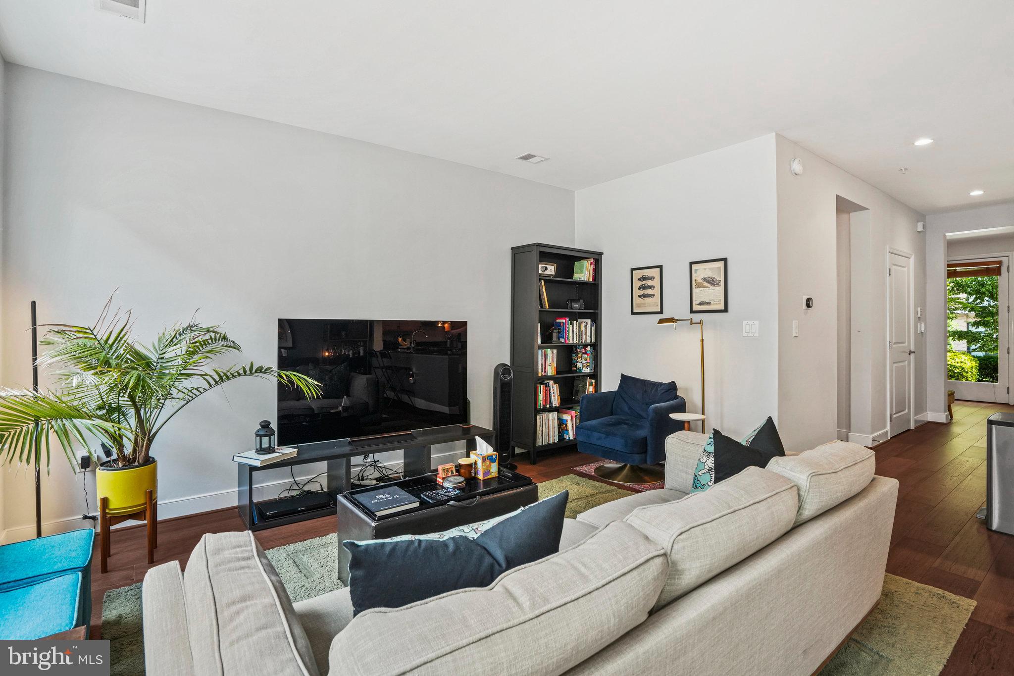 1811 14th Street North, Unit C104 Arlington, VA 22209 - Photo 12 of 44 a living room with furniture and a flat screen tv