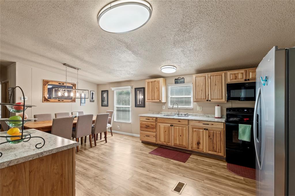 194 Indian Gap Road Mabank, TX 75156 - Photo 6 of 18 a kitchen with stainless steel appliances granite countertop a sink and cabinets