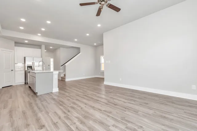 a open kitchen with stainless steel appliances granite countertop a sink stove and refrigerator