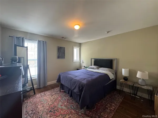 a spacious bedroom with a bed and a table in it