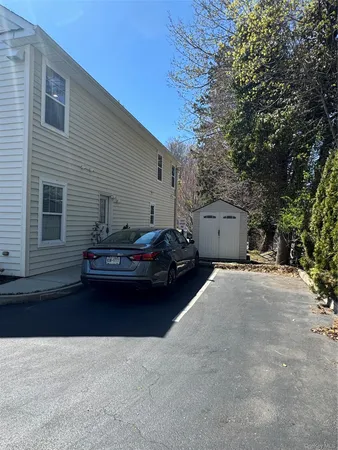 a couple of cars parked in front of a house