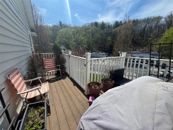 a view of a roof deck with wooden floor and fence