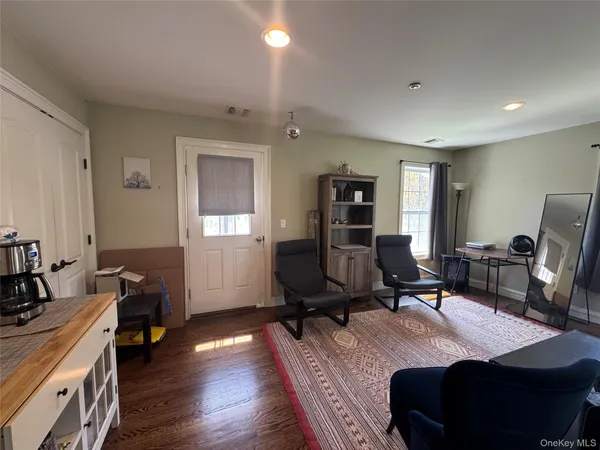 a view of a workspace with furniture and a window