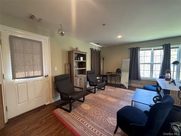 a living room with furniture a rug and a window