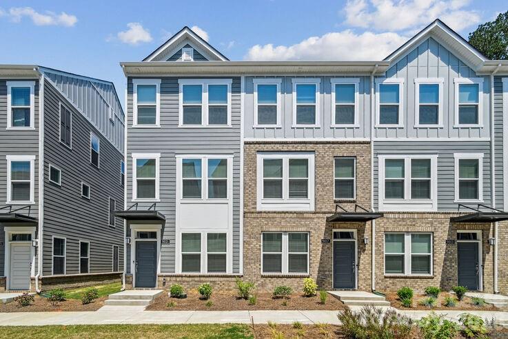 4375 Raleigh Street, Unit C1 Charlotte, NC 28213 - Photo 17 of 19 a front view of a residential apartment building with a yard