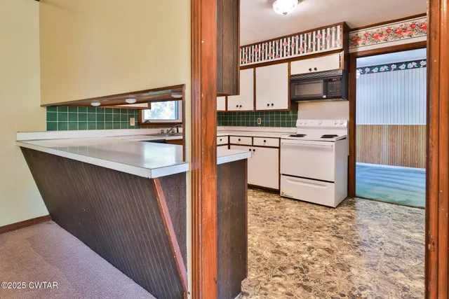 a kitchen with a refrigerator and a stove