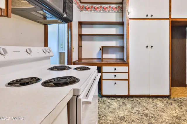 a kitchen with a appliances a stove and a refrigerator