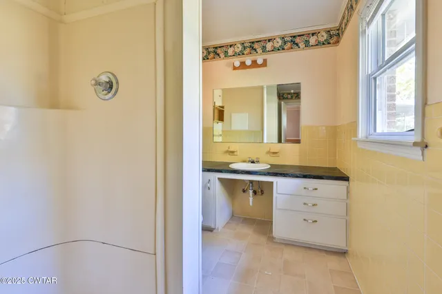 a bathroom with a granite countertop sink mirror and a