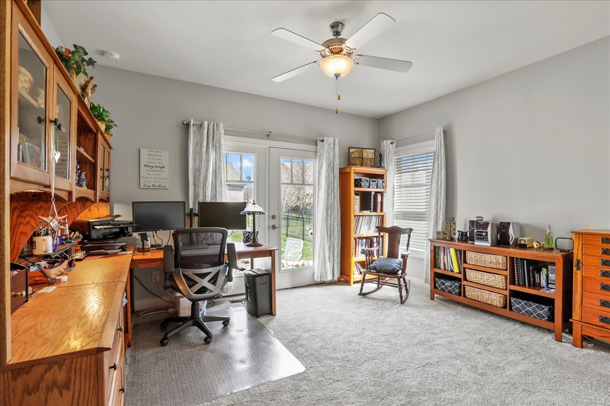 1604 Kassen Avenue Mahomet, IL 61853 - Photo 18 of 35 a living room with furniture gym equipment and a chandelier