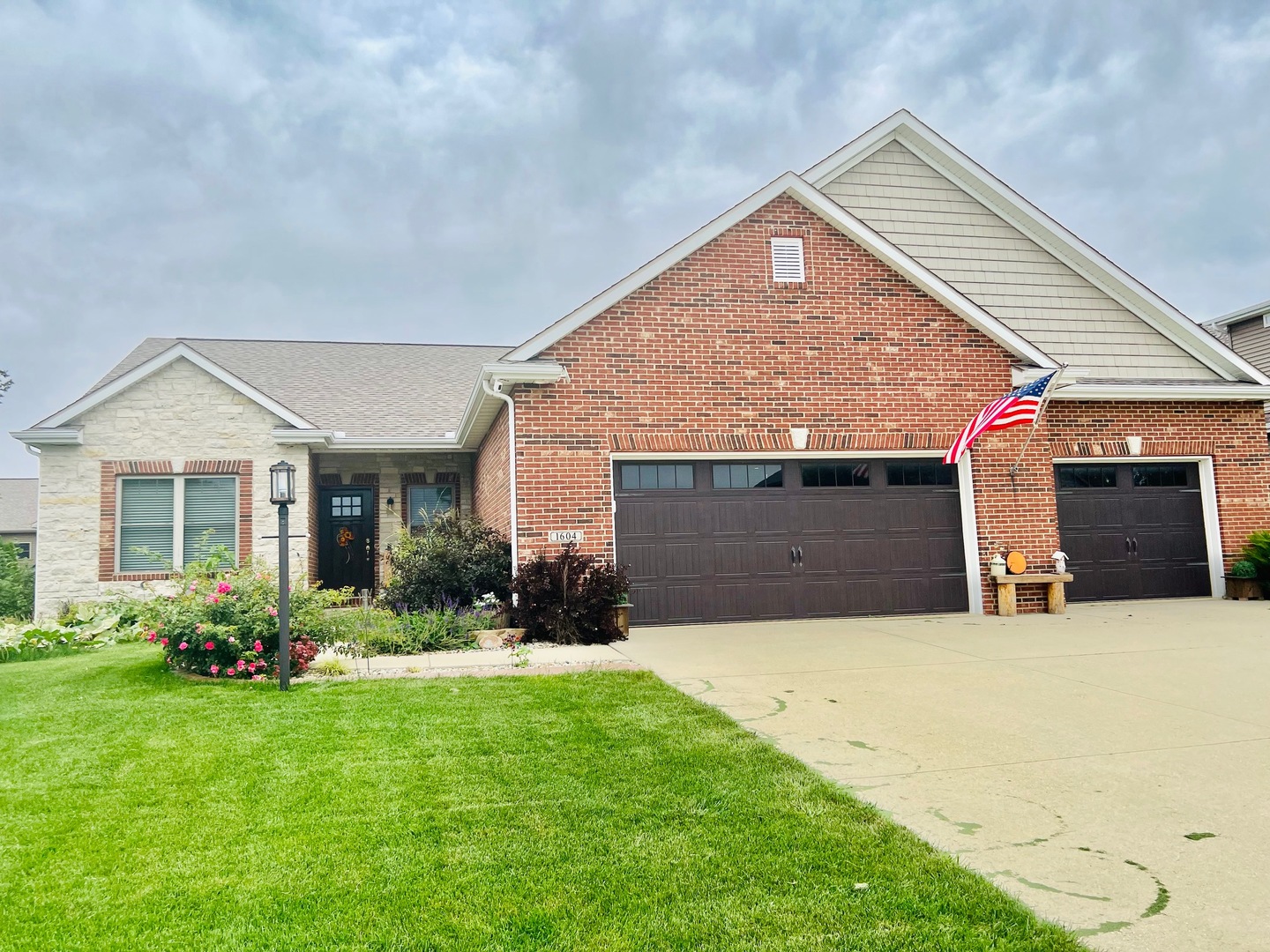 1604 Kassen Avenue Mahomet, IL 61853 - Photo 2 of 35 a front view of a house with a yard and garage