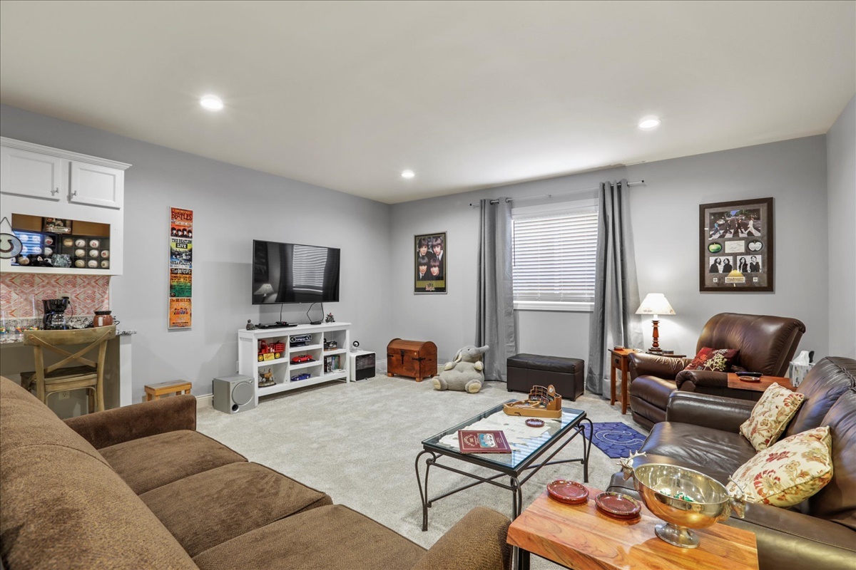 1604 Kassen Avenue Mahomet, IL 61853 - Photo 23 of 35 a living room with furniture a flat screen tv and a window
