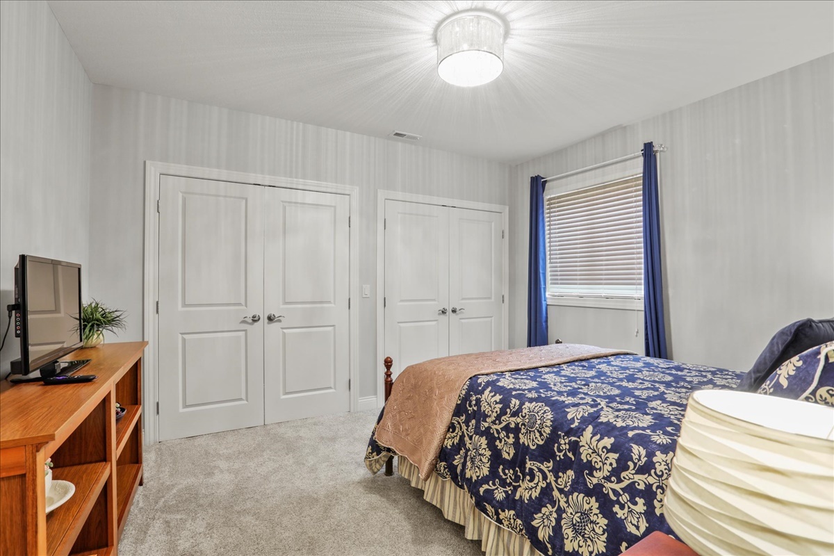 1604 Kassen Avenue Mahomet, IL 61853 - Photo 24 of 35 a bedroom with a bed and a chandelier