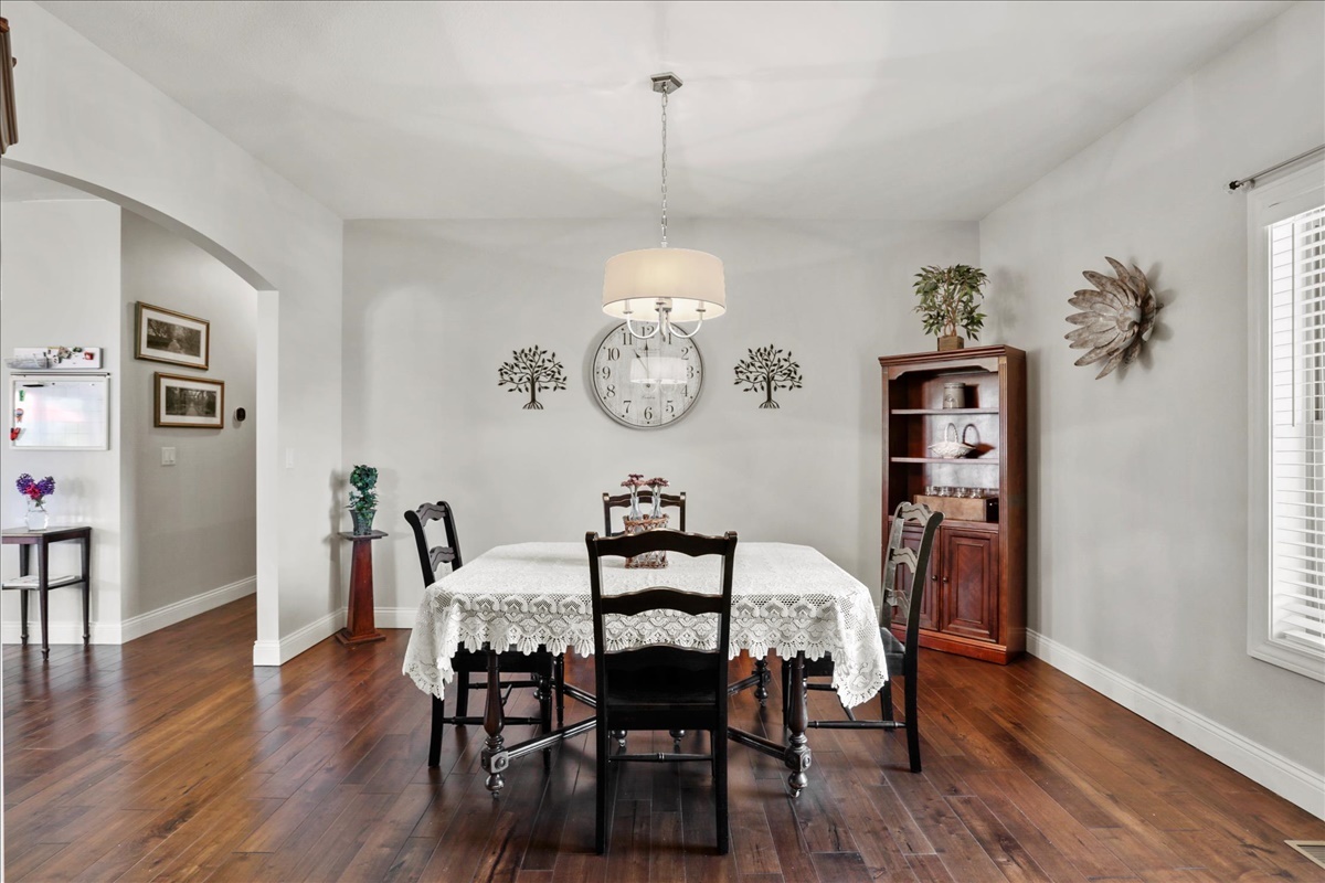 1604 Kassen Avenue Mahomet, IL 61853 - Photo 5 of 35 a dining room with furniture a chandelier and wooden floor