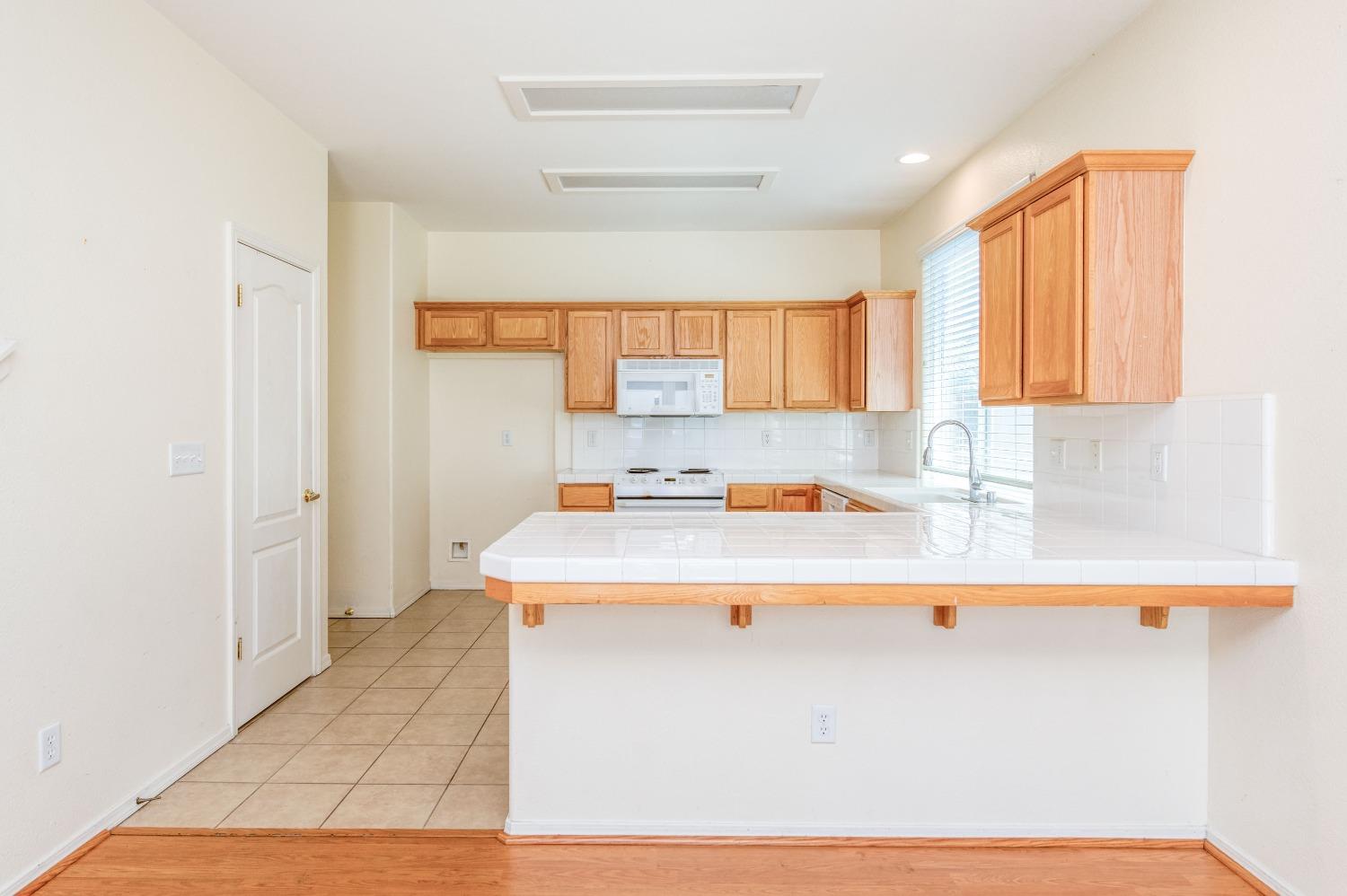 694 West Lisbon Lane Clovis, CA 93619 - Photo 11 of 39 a view of kitchen with stainless steel appliances granite countertop a sink and a white cabinets