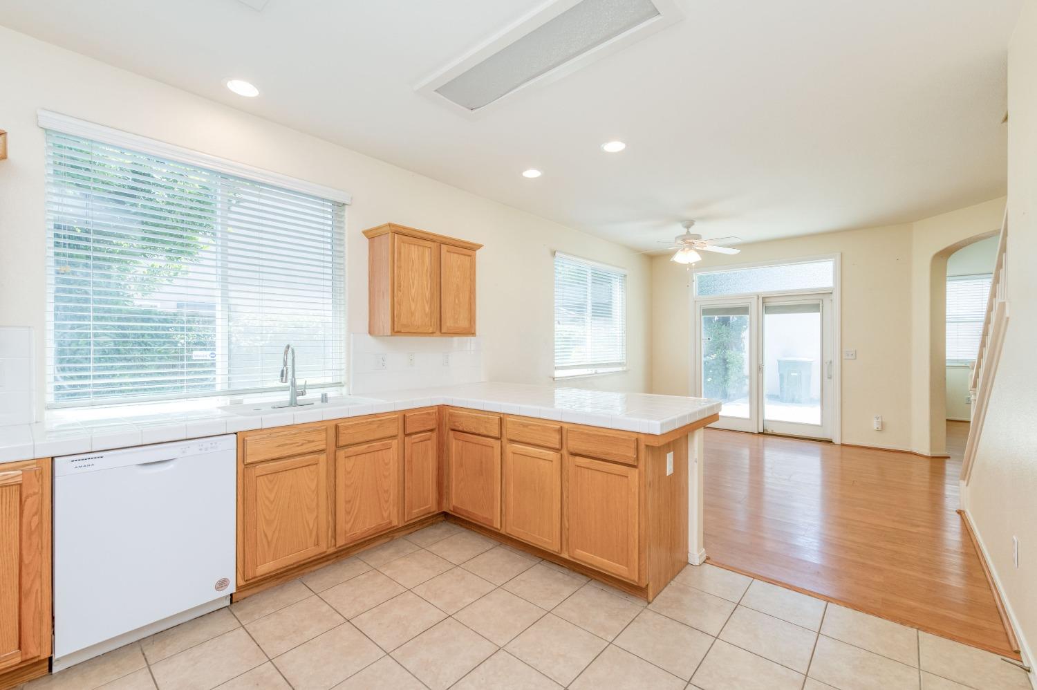 694 West Lisbon Lane Clovis, CA 93619 - Photo 14 of 39 a large kitchen with stainless steel appliances granite countertop a sink and a stove