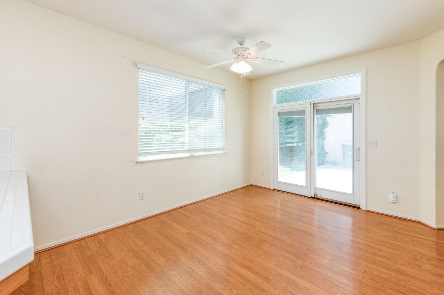 694 West Lisbon Lane Clovis, CA 93619 - Photo 15 of 39 a view of an empty room with wooden floor and a window