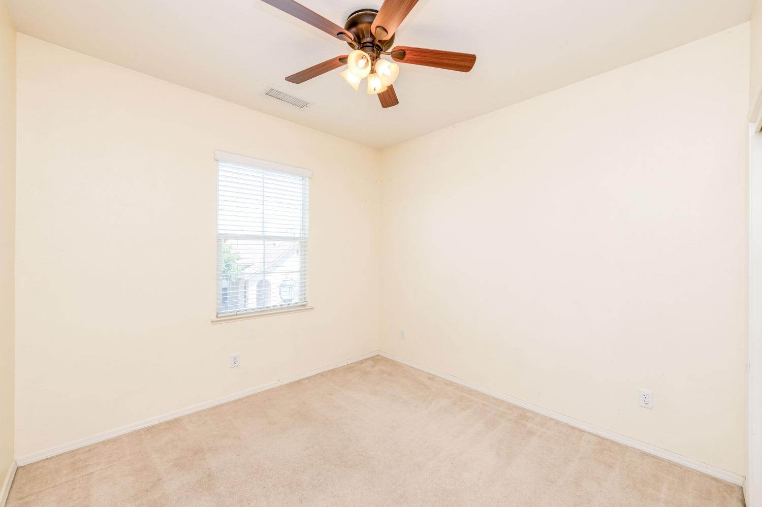 694 West Lisbon Lane Clovis, CA 93619 - Photo 18 of 39 an empty room with windows and fan