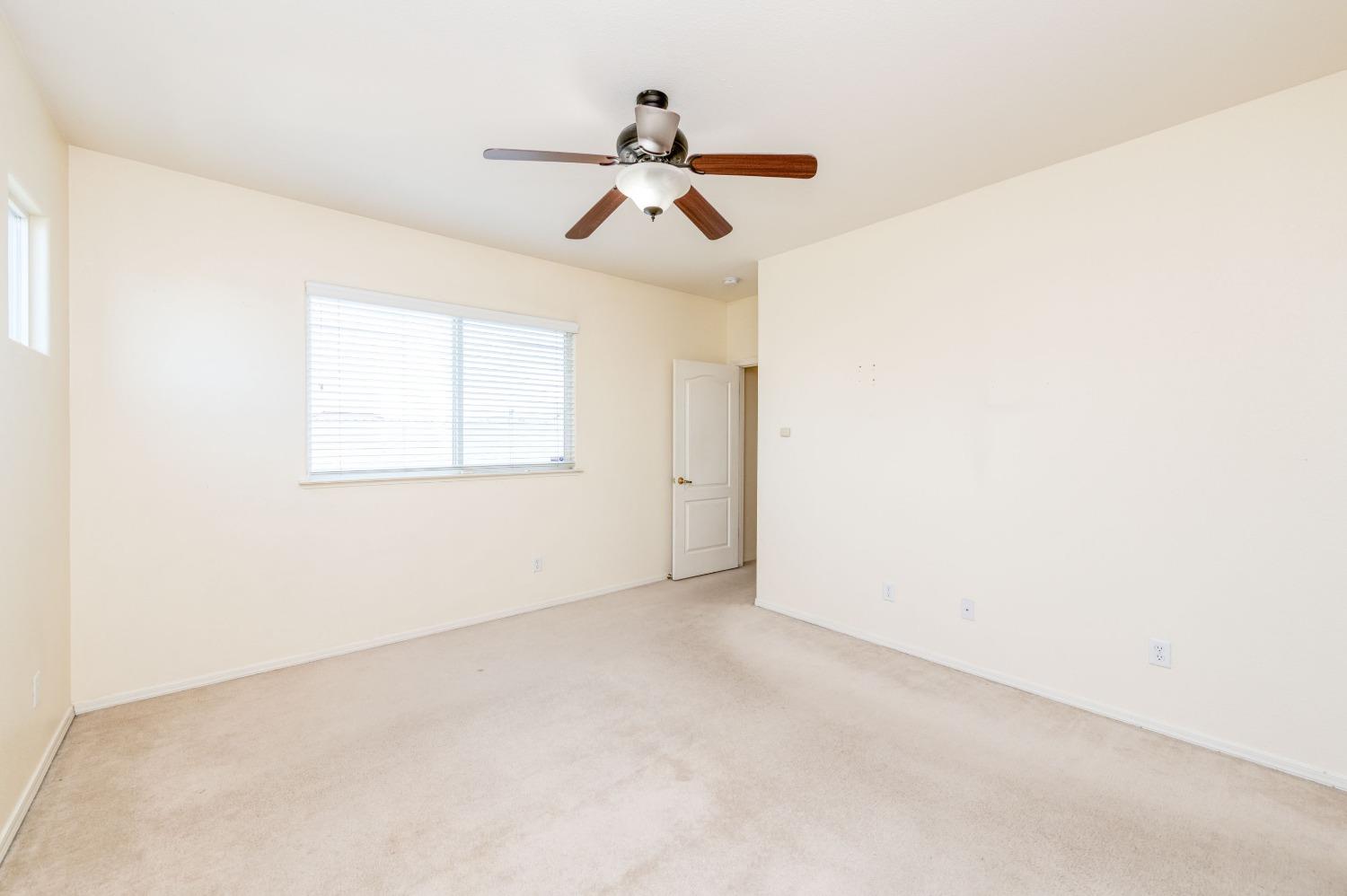 694 West Lisbon Lane Clovis, CA 93619 - Photo 22 of 39 an empty room with windows and fan