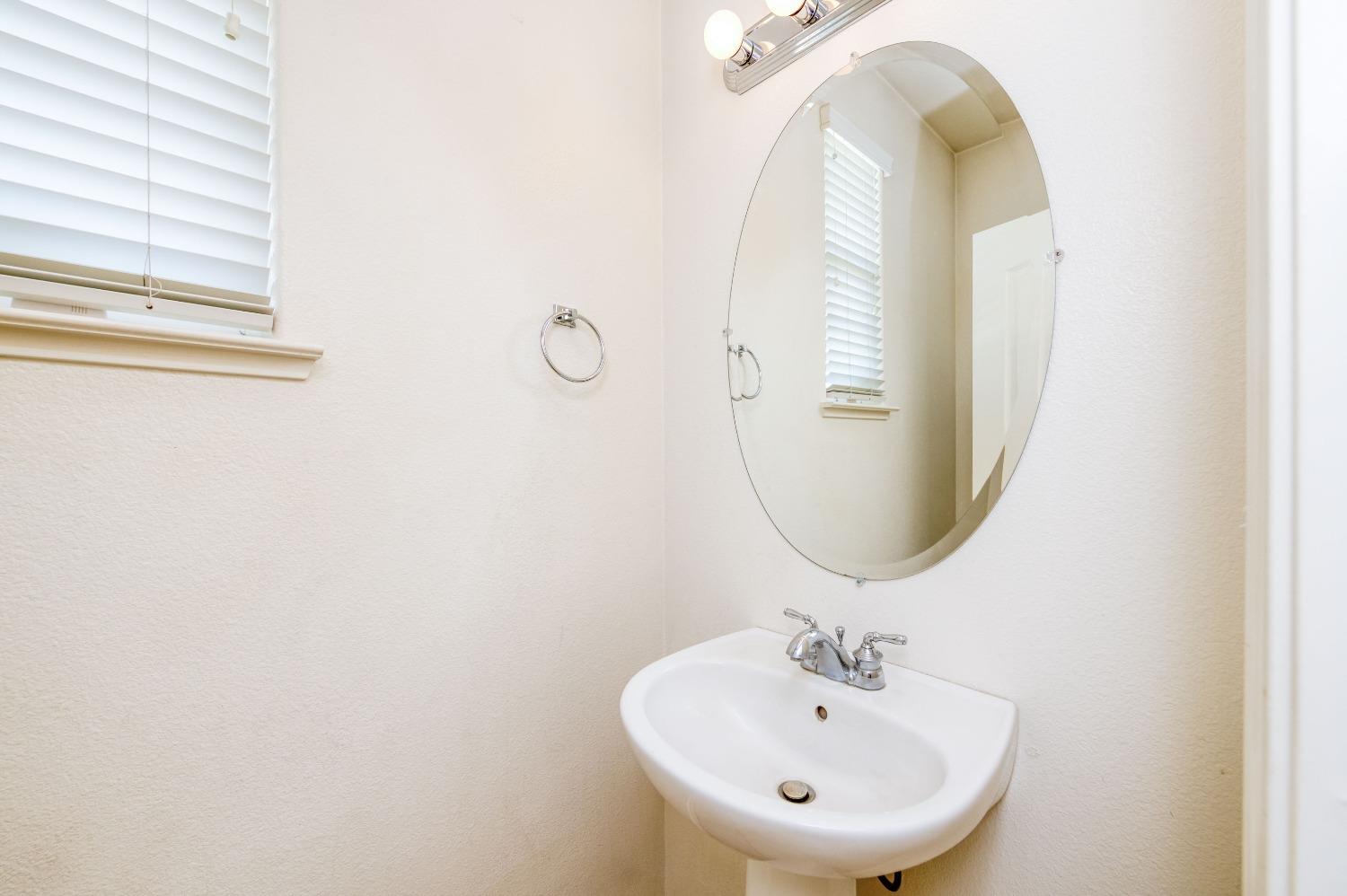 694 West Lisbon Lane Clovis, CA 93619 - Photo 25 of 39 a bathroom with a sink and a mirror