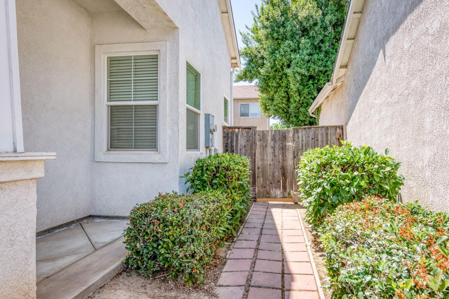 694 West Lisbon Lane Clovis, CA 93619 - Photo 26 of 39 a view of a pathway with flower pots