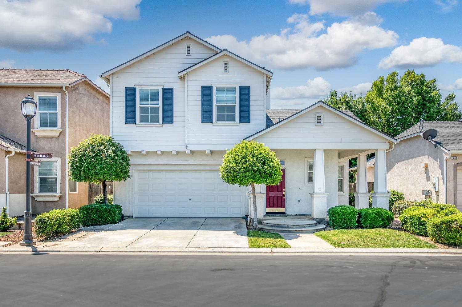 694 West Lisbon Lane Clovis, CA 93619 - Photo 33 of 39 a front view of a house with a yard and garage