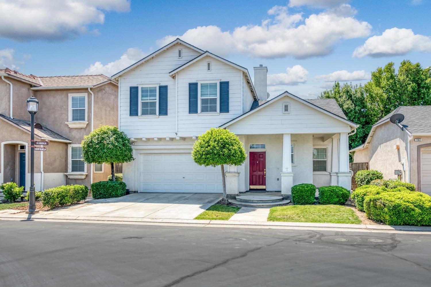 694 West Lisbon Lane Clovis, CA 93619 - Photo 35 of 39 a view of front a house with a yard and potted plants
