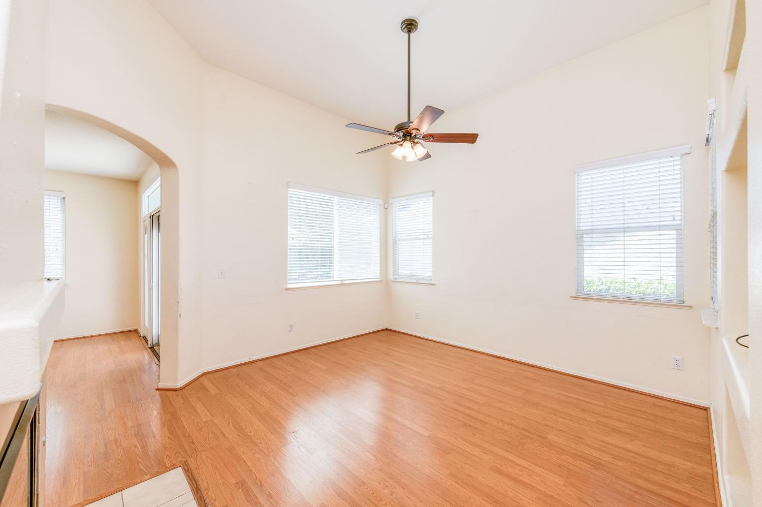 694 West Lisbon Lane Clovis, CA 93619 - Photo 4 of 39 a view of empty room with wooden floor and fan