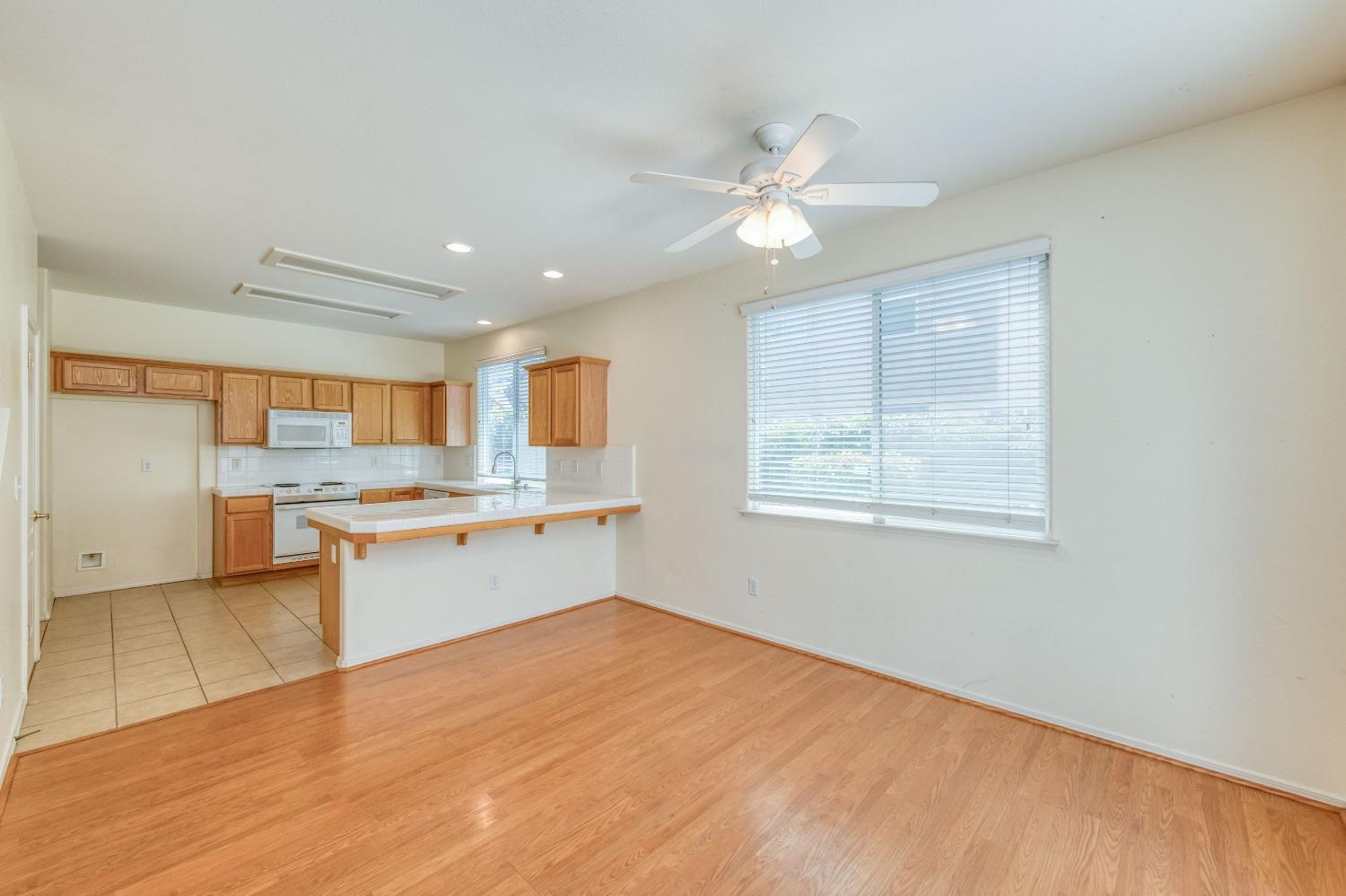 694 West Lisbon Lane Clovis, CA 93619 - Photo 9 of 39 a large white kitchen with a large window