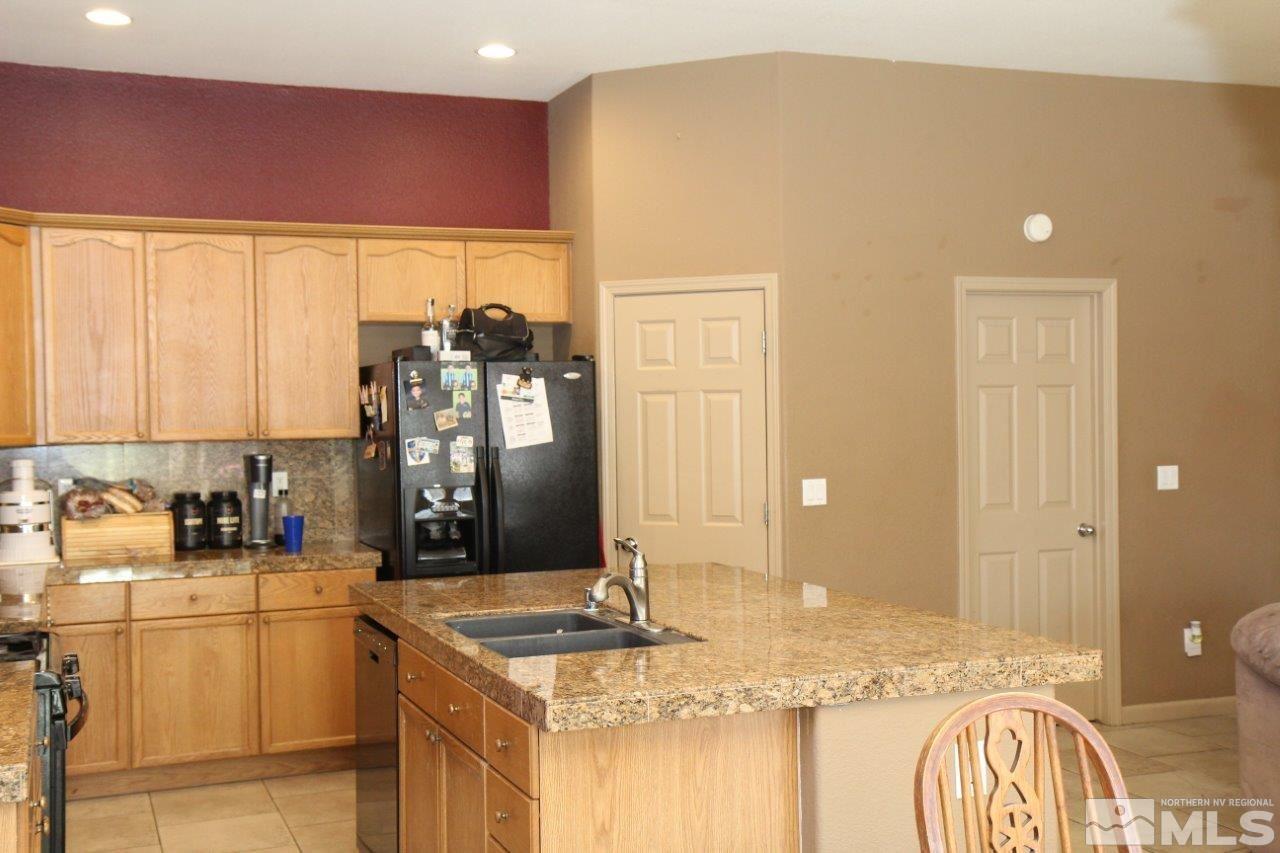 2550 Perryville Drive Reno, NV 89521 - Photo 2 of 30 a bathroom with a granite countertop sink and a mirror