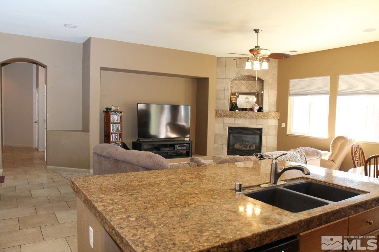 2550 Perryville Drive Reno, NV 89521 - Photo 3 of 30 a kitchen with kitchen island granite countertop a sink and a refrigerator
