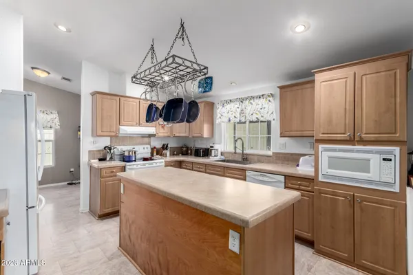 a kitchen with stainless steel appliances a sink stove and refrigerator
