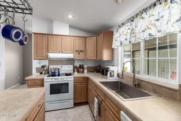 a kitchen that has a sink a stove and window