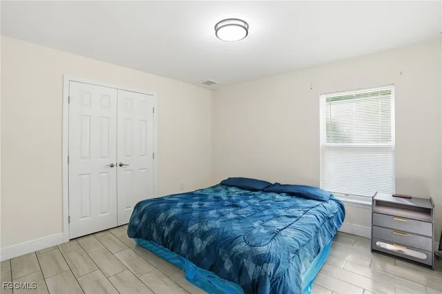 a bedroom with a bed and cabinets