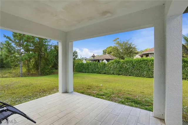 a view of a backyard and floor to ceiling window