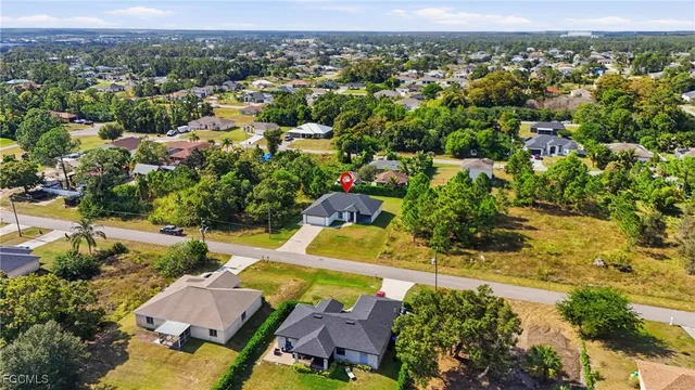 an aerial view of a house with a yard